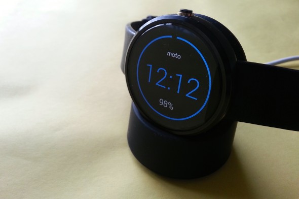 The Moto 360 in its charging cradle